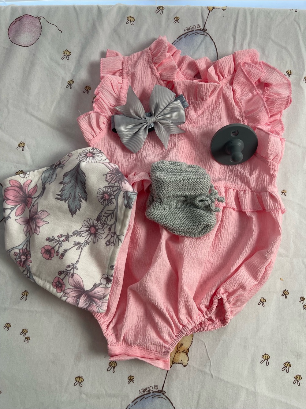 Soft Pink Ruffled Baby One-Piece Romper with Gray Bow